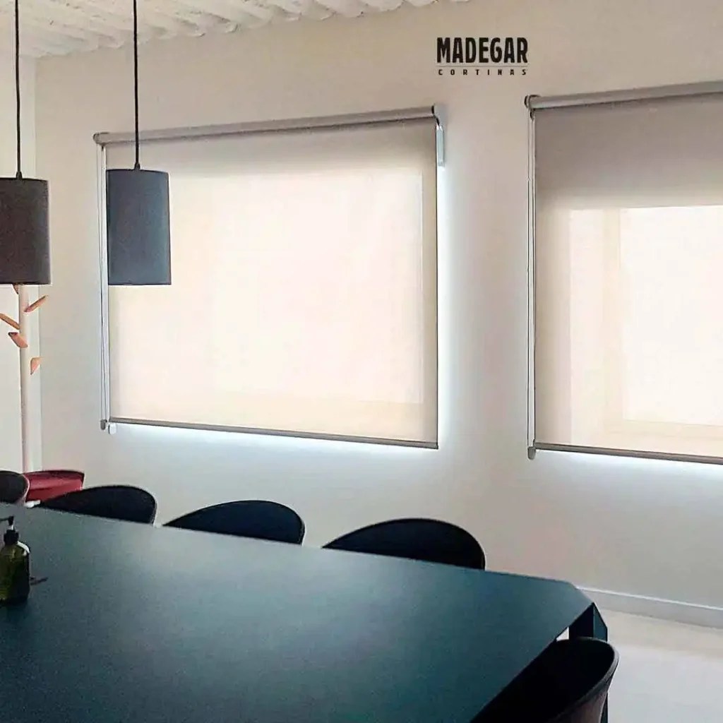 Estores screen a medida para control solar eficiente en oficinas. Los estores filtran la luz exterior eliminando reflejos en pantallas, ideales para espacios de trabajo tecnológicos.